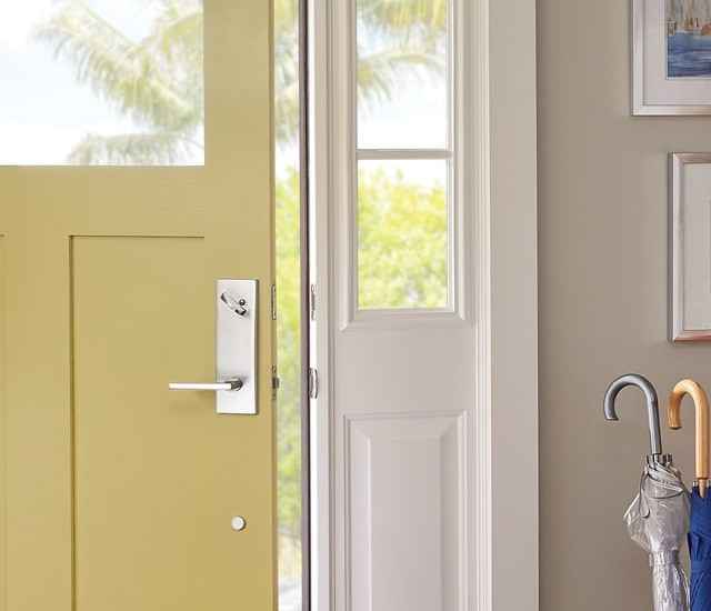 Schlage latitude lever in Bright Chrome on yellow front door.