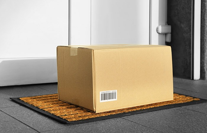 Package sitting unattended on a welcome mat.