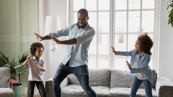 Dad dancing with two children