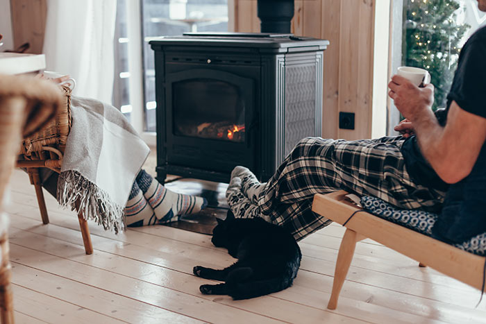 Family with cat relaxing by the fire place