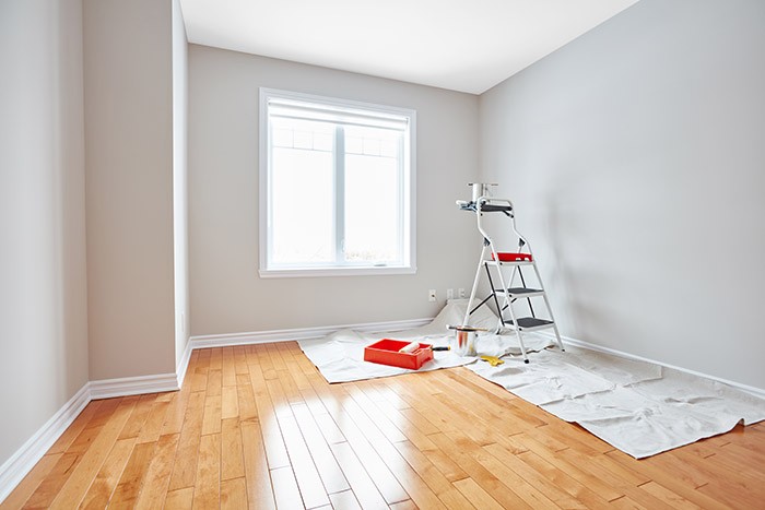 House renovation with painting supplies on the ground