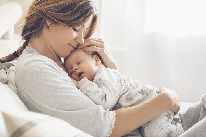 Mom holding sleeping baby on chest