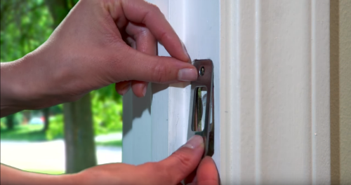 Use the remaining two short screws to secure the strike plate over the reinforcement plate or directly to the door frame.