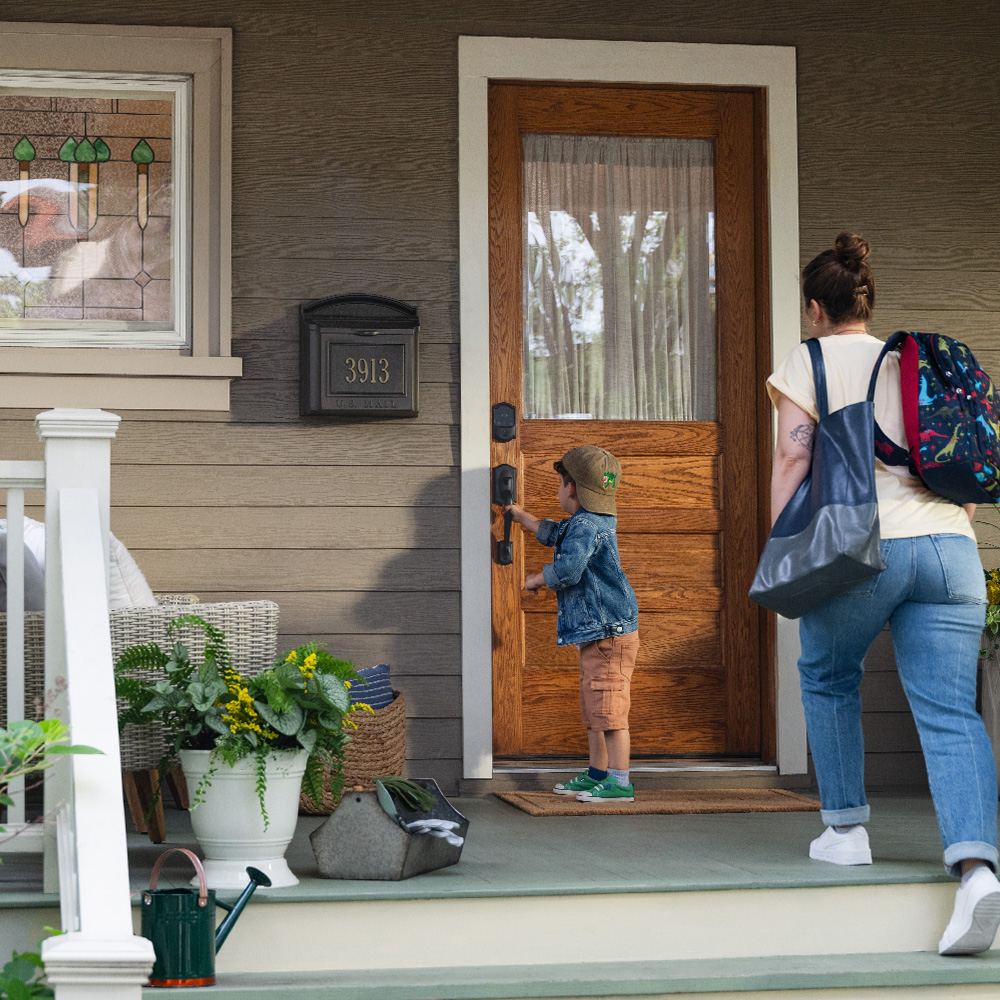 Busy mom entering home with child.