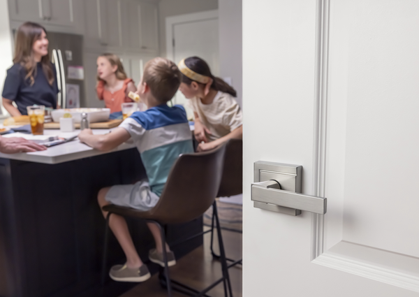 family gathering in kitchen with modern door lever